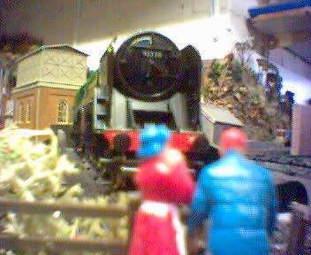 Two walkers stop to watch No.5 'Gandalf' on the turntable at Michel Delving.
